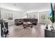 Spacious living room featuring a large leather sofa, multiple windows with natural light, and tile floors at 5351 Bridge St # 16, Tampa, FL 33611