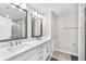 Elegant main bathroom boasts dual sinks, modern fixtures, and a glass-enclosed shower for a spa-like experience at 5351 Bridge St # 16, Tampa, FL 33611