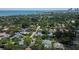 This aerial image captures neighborhood homes surrounded by lush trees near the beach at 555 21St Ne Ave, St Petersburg, FL 33704