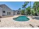 Inviting backyard oasis boasts a pool, expansive patio, and mature palm trees at 555 21St Ne Ave, St Petersburg, FL 33704