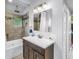 Updated bathroom featuring a tiled shower and tub combination and dark wood vanity with white countertop at 555 21St Ne Ave, St Petersburg, FL 33704