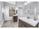 Beautifully updated bathroom with double sinks, walk-in shower, tub and modern fixtures at 555 21St Ne Ave, St Petersburg, FL 33704