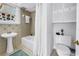 Cozy bathroom featuring a classic pedestal sink and tiled tub-shower combo at 555 21St Ne Ave, St Petersburg, FL 33704