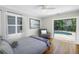 Bright bedroom boasts hardwood floors, slider door to pool, and a serene view at 555 21St Ne Ave, St Petersburg, FL 33704