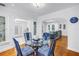 Bright dining room with a glass table and seating for four overlooks the living room at 555 21St Ne Ave, St Petersburg, FL 33704
