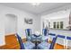 Dining room with seating for four, wood floors, and an open view of the updated kitchen at 555 21St Ne Ave, St Petersburg, FL 33704