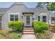 Charming home exterior featuring well-manicured landscaping, walkway, and a covered entry at 555 21St Ne Ave, St Petersburg, FL 33704