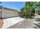 View of the home's detached garage with ample driveway space and mature palms at 555 21St Ne Ave, St Petersburg, FL 33704