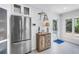Bright kitchen boasts a large stainless fridge and view of backyard and pool at 555 21St Ne Ave, St Petersburg, FL 33704