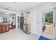 Bright kitchen area featuring stainless steel refrigerator, decoratively painted cabinet, and doorway to outside at 555 21St Ne Ave, St Petersburg, FL 33704