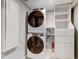 Laundry room featuring stacked washer and dryer, a cabinet and closet space at 555 21St Ne Ave, St Petersburg, FL 33704