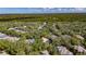 Expansive aerial view of a house nestled among mature trees in a lush green neighborhood on an oversized lot at 5804 Terncrest Dr, Lithia, FL 33547