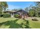 A backyard with a pool, privacy screening, lush landscaping and a fire pit at 5804 Terncrest Dr, Lithia, FL 33547