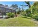 A backyard with a pool, privacy screening, lush landscaping and a fire pit at 5804 Terncrest Dr, Lithia, FL 33547