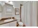 Clean bathroom features granite countertop, white cabinets and shower-tub combo at 5804 Terncrest Dr, Lithia, FL 33547