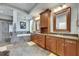 Bright bathroom with dual sinks, wooden cabinets, and separate tub and shower at 5804 Terncrest Dr, Lithia, FL 33547
