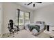 Cozy bedroom featuring neutral tones, two windows, and a ceiling fan at 5804 Terncrest Dr, Lithia, FL 33547