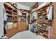 Walk-in closet with custom shelving, racks, and drawers for ample storage at 5804 Terncrest Dr, Lithia, FL 33547