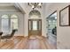 Bright foyer with arched windows, decorative front door, high ceilings, and wood flooring at 5804 Terncrest Dr, Lithia, FL 33547