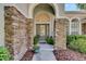 Inviting front entrance with stone accents, arched doorway, and decorative glass door at 5804 Terncrest Dr, Lithia, FL 33547