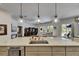 Open kitchen featuring a large island, pendant lighting, and views to the living room at 5804 Terncrest Dr, Lithia, FL 33547
