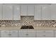 Modern kitchen with white cabinets, quartz countertops, and gas cooktop at 5804 Terncrest Dr, Lithia, FL 33547