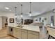Spacious kitchen island with sink, open to the living room and dining area at 5804 Terncrest Dr, Lithia, FL 33547