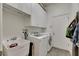 Efficient laundry room with a washer, dryer, sink, and ample cabinet storage at 5804 Terncrest Dr, Lithia, FL 33547