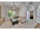 Spacious living room featuring large windows and plush sofa at 5804 Terncrest Dr, Lithia, FL 33547