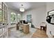 Bright home office with arched windows, wood floors, and modern desk setup at 5804 Terncrest Dr, Lithia, FL 33547