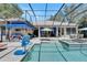 Spacious screened pool area featuring a spa, seating, and covered patio at 5804 Terncrest Dr, Lithia, FL 33547