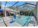 Screened-in pool area has a spa, seating and an umbrella for shade on sunny days at 5804 Terncrest Dr, Lithia, FL 33547