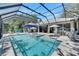 Resort-style screened pool area with a spa, lounge seating, and outdoor dining at 5804 Terncrest Dr, Lithia, FL 33547