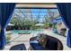 Screened pool area featuring a spa, comfortable seating, and lush landscaping at 5804 Terncrest Dr, Lithia, FL 33547