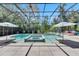 A screened-in pool features a spa, umbrella-covered tables and lounge chairs at 5804 Terncrest Dr, Lithia, FL 33547