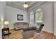 Cozy sitting room with tray ceiling, wood flooring, and comfortable seating arrangement at 5804 Terncrest Dr, Lithia, FL 33547