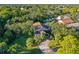An aerial view of the home with mature landscaping and a long driveway at 5908 Mohr Rd, Tampa, FL 33615