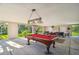 Spacious covered outdoor entertainment area featuring a pool table and seating at 5908 Mohr Rd, Tampa, FL 33615