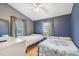 Bright bedroom featuring two twin beds, wood floors, and lots of natural light at 5908 Mohr Rd, Tampa, FL 33615