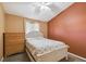 Comfortable bedroom with plush carpet, a ceiling fan, and a large dresser at 5908 Mohr Rd, Tampa, FL 33615