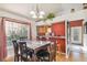 Bright dining room with natural light, chandelier, and access to the kitchen area at 5908 Mohr Rd, Tampa, FL 33615