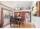 A dining room with wood floors, chandelier, and large window allowing for plenty of natural light at 5908 Mohr Rd, Tampa, FL 33615