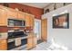 Kitchen features stainless steel appliances, granite countertops, and wood cabinets with ample storage at 5908 Mohr Rd, Tampa, FL 33615