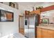 Modern kitchen with stainless steel refrigerator, wood cabinets and tiled floors at 5908 Mohr Rd, Tampa, FL 33615