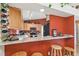 Kitchen counter and breakfast bar featuring granite countertops, wood cabinets, and stainless steel appliances at 5908 Mohr Rd, Tampa, FL 33615
