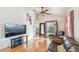 Bright living room with vaulted ceilings, wood floors, ceiling fan, and comfortable seating at 5908 Mohr Rd, Tampa, FL 33615