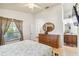 Bright bedroom features hardwood floors, natural light, dresser and access to the bathroom at 5908 Mohr Rd, Tampa, FL 33615