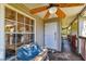 Inviting front porch featuring a ceiling fan, perfect for enjoying warm days on the wood deck at 5908 Mohr Rd, Tampa, FL 33615