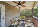 This outdoor space has a wood deck, ceiling fan, table and chairs, and a great view of the natural landscape at 5908 Mohr Rd, Tampa, FL 33615