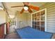 Relaxing covered porch featuring a wood ceiling fan and comfortable hammock, perfect for enjoying the outdoors at 5908 Mohr Rd, Tampa, FL 33615